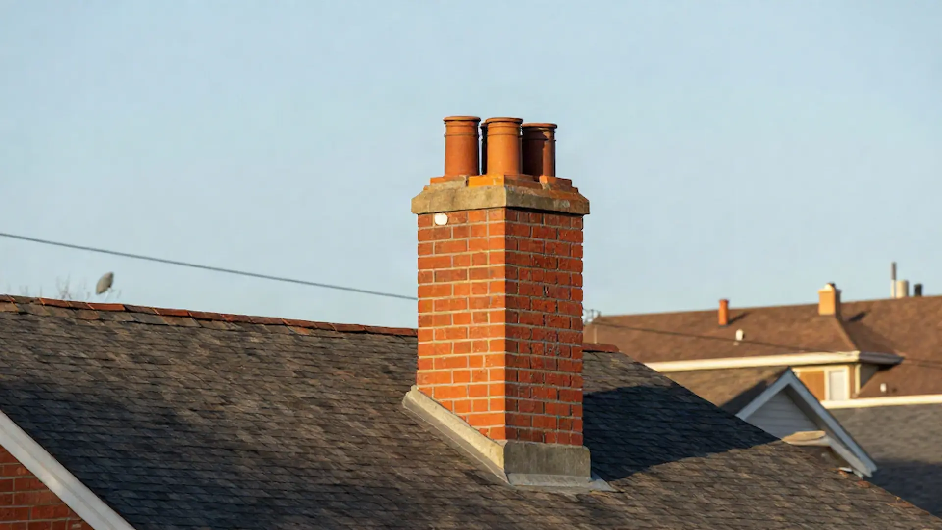 Brick chimney on a home served by Blue Star Chimney Services in Chicago, IL